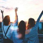 women forming heart gestures during daytime