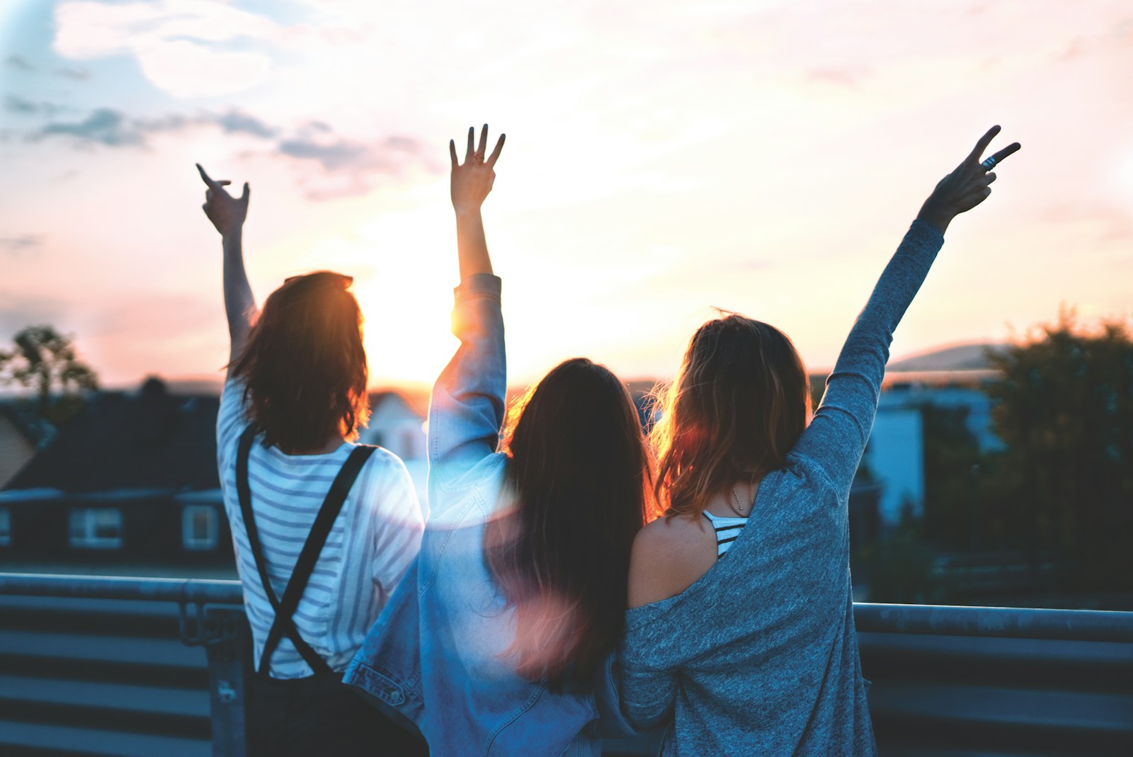 women forming heart gestures during daytime